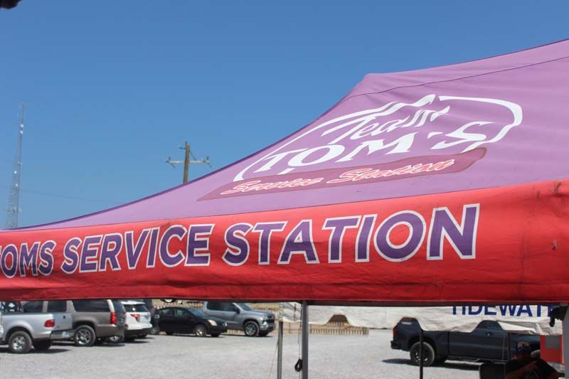 A red and purple tent with the word service station on it