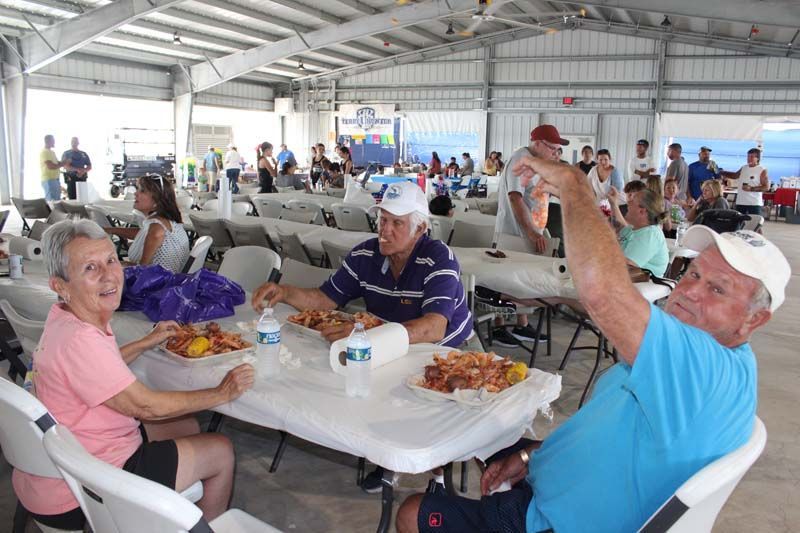 A group of people are sitting at tables eating food