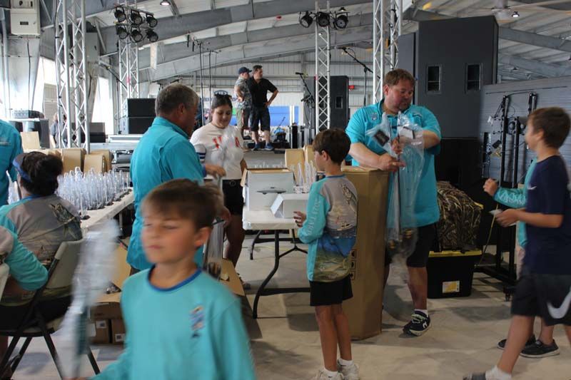 A group of people are standing around a table in a room.