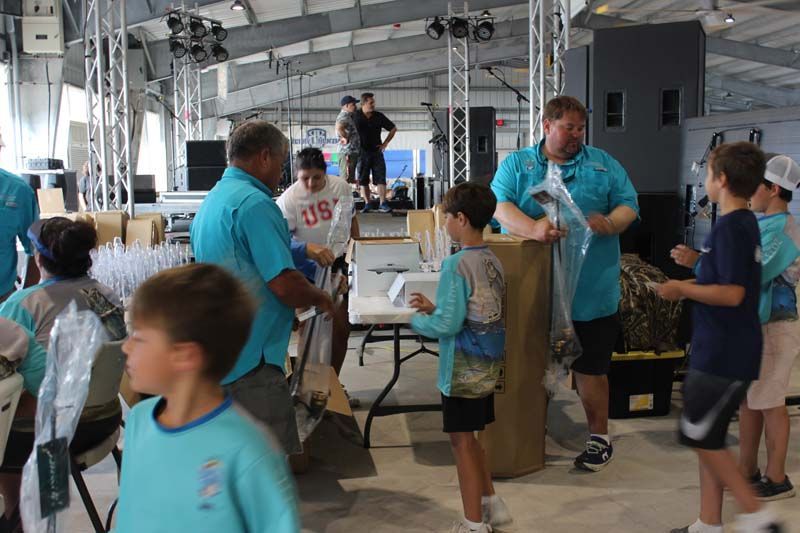 A group of people are standing around a table in a room.