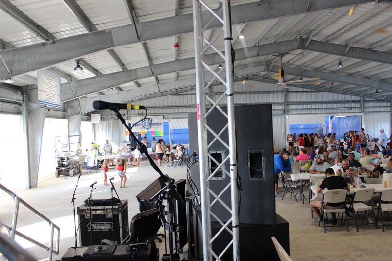 A large room with a lot of people sitting at tables