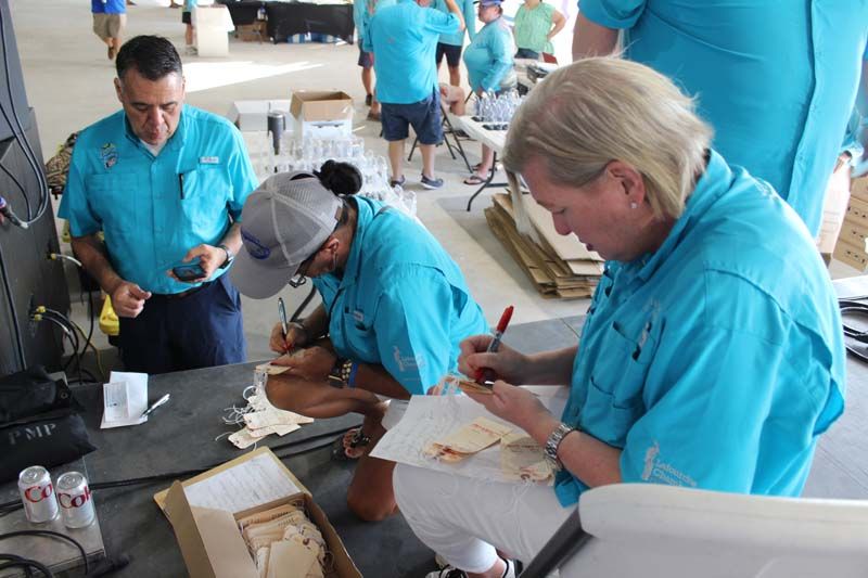 A group of people in blue shirts are working on a project