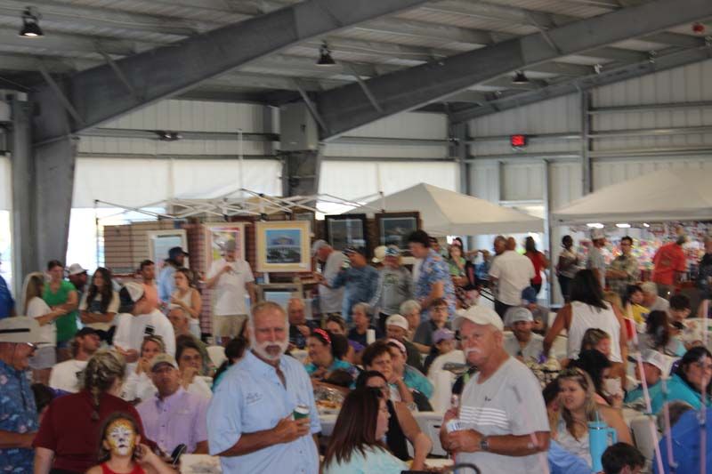 A large group of people are gathered inside of a building