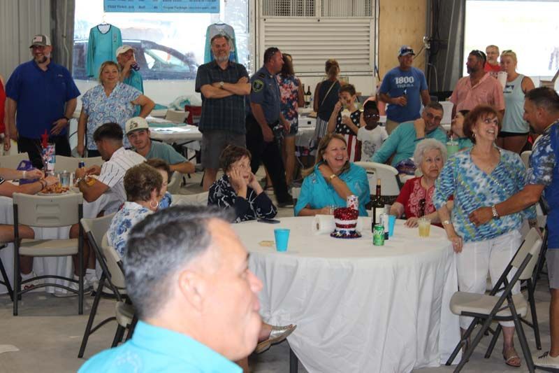 A group of people are sitting at tables in a room.
