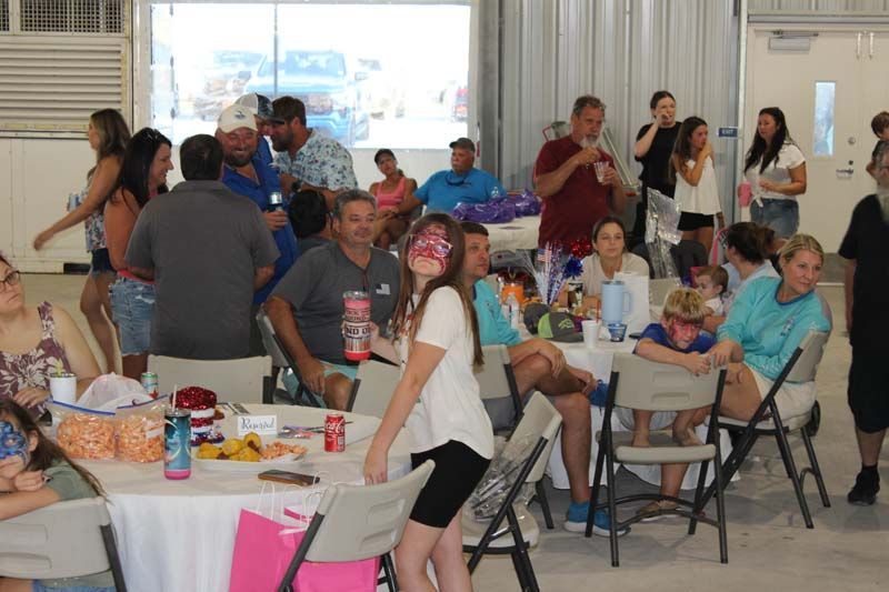 A group of people are sitting at tables in a room.