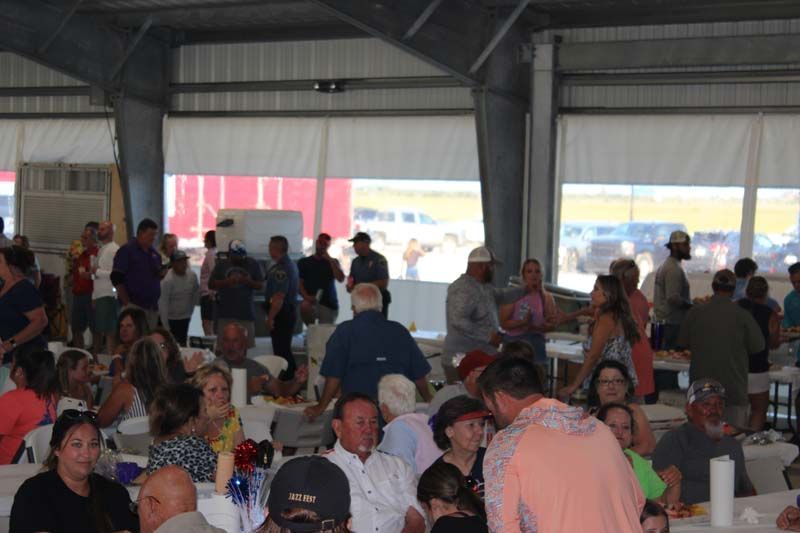 A large group of people are sitting at tables in a room.