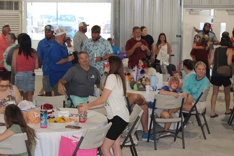 A group of people are sitting at tables in a room.