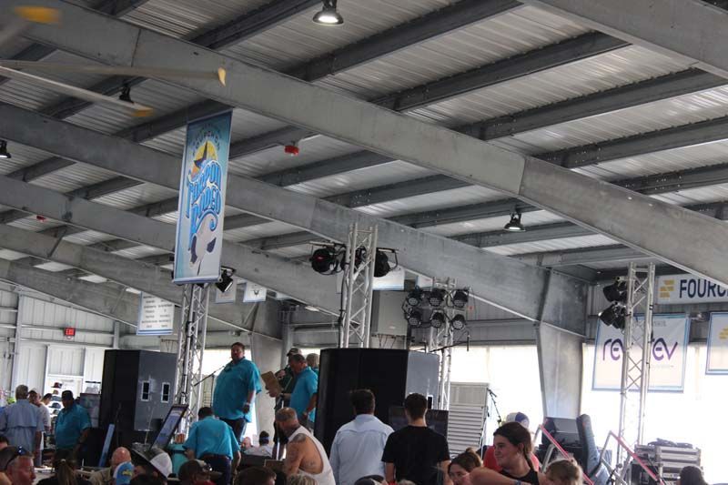 A large group of people are gathered inside of a building