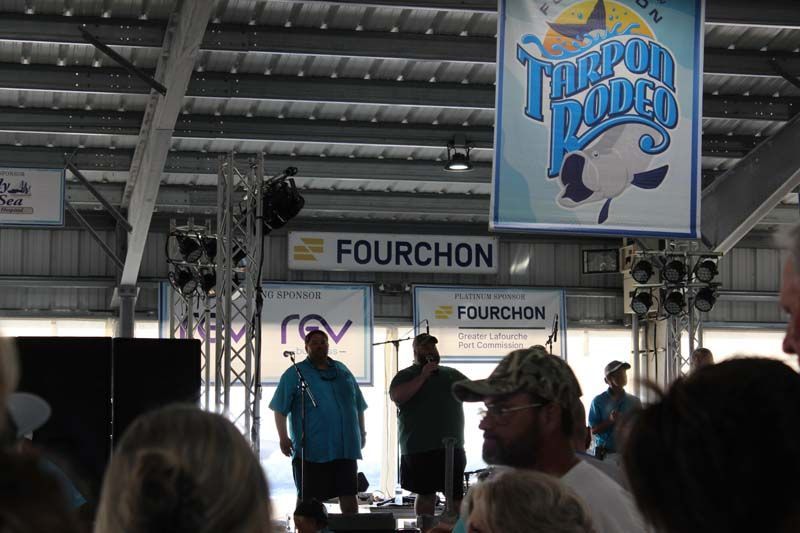 A group of people standing in front of a sign that says fourchon