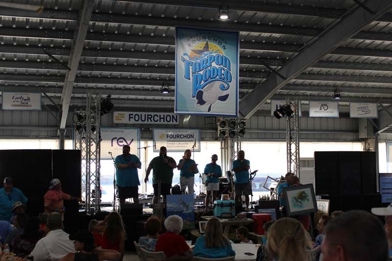 A group of people standing in front of a sign that says fourchon