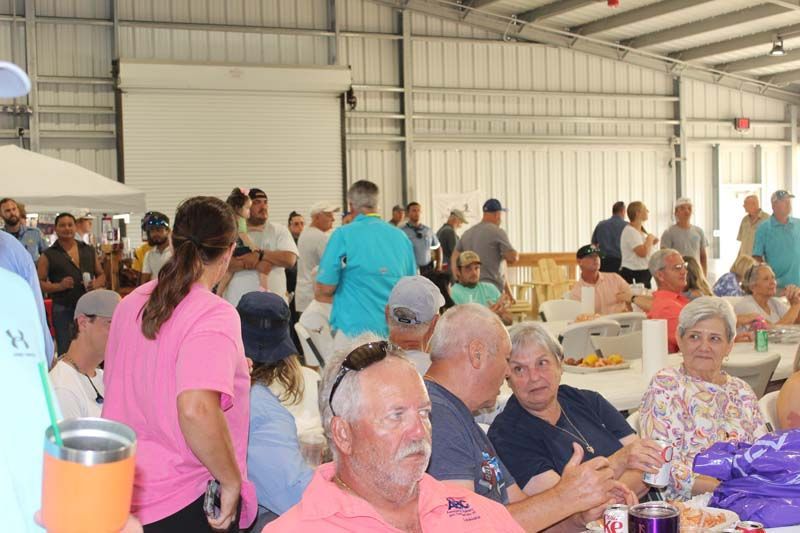A large group of people are sitting at tables in a building.
