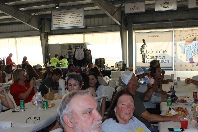 A group of people are sitting at tables in a room.