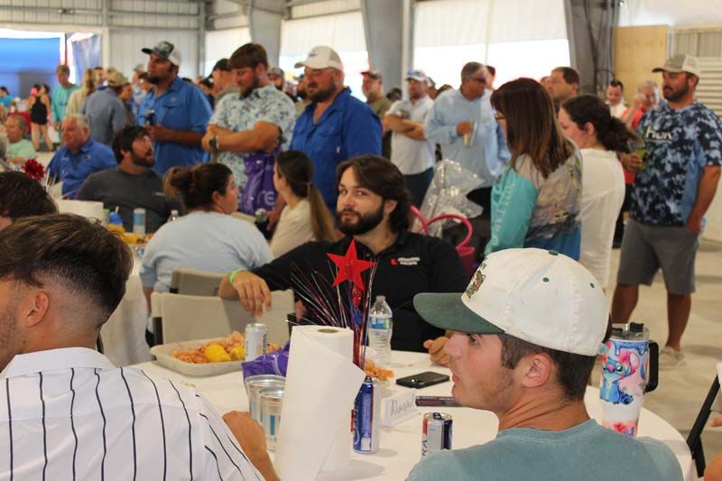 A group of people are sitting at tables in a room.