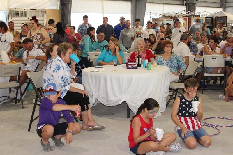 A group of people are sitting at tables in a room.