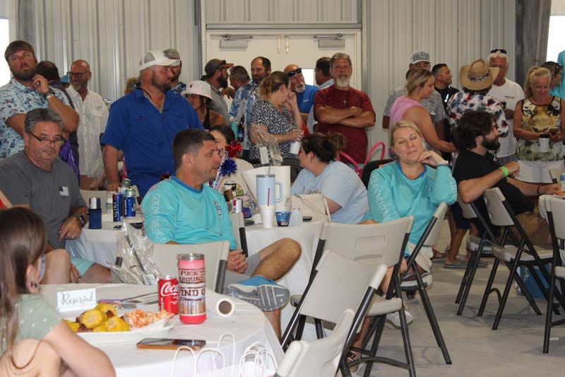 A large group of people are sitting at tables in a room.