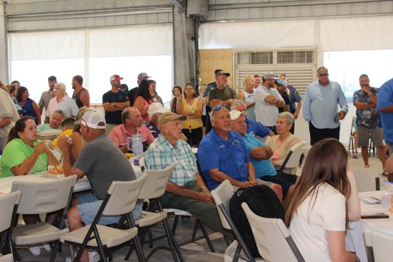 A group of people are sitting in folding chairs in a room.