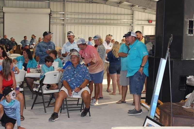 A group of people are sitting in chairs in a room.