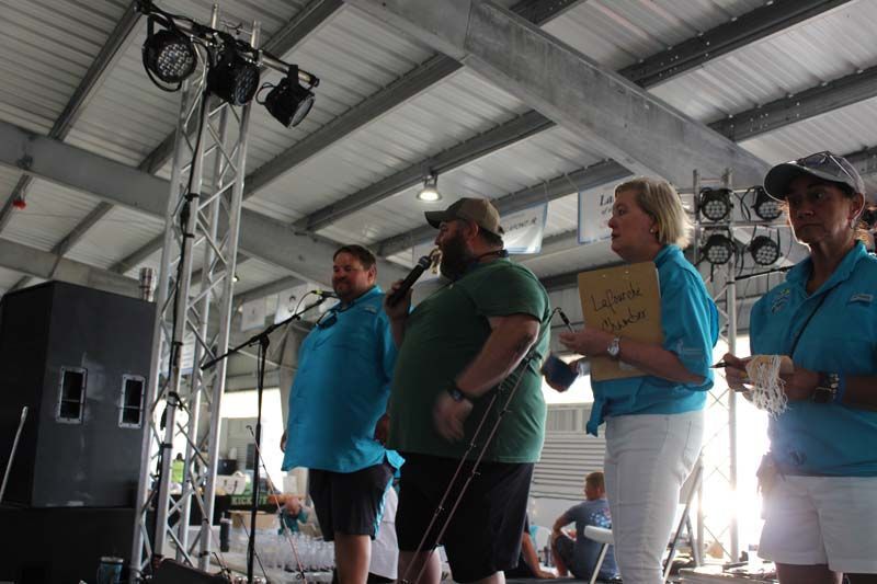 A group of people are standing in front of a microphone.