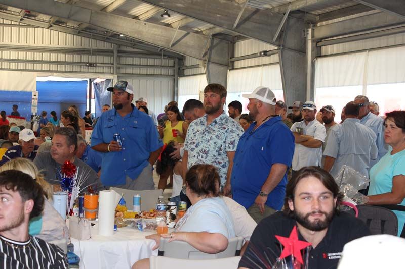 A group of people are sitting at tables in a room.
