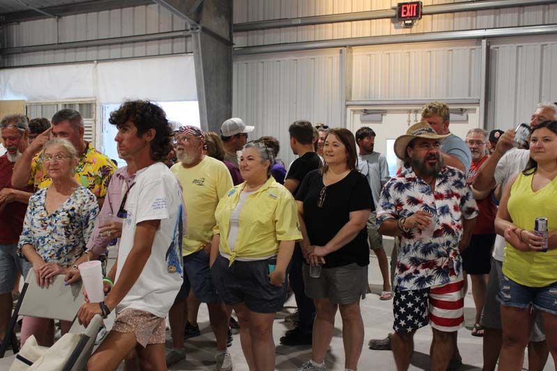 A large group of people are standing in a room.