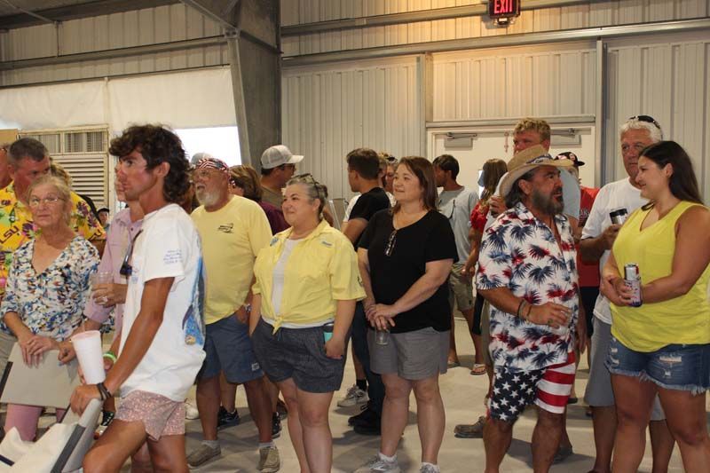 A large group of people are standing in a room.