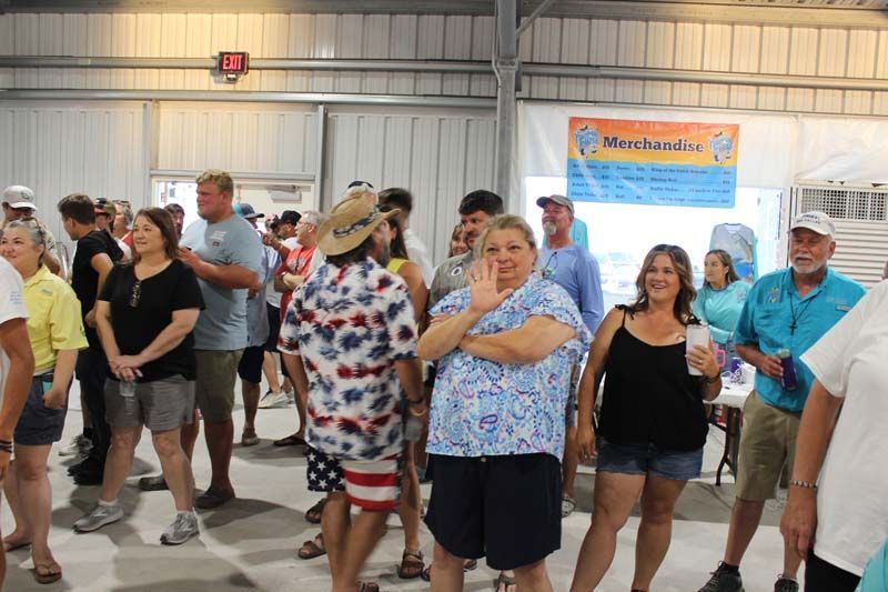 A large group of people are standing in a room.