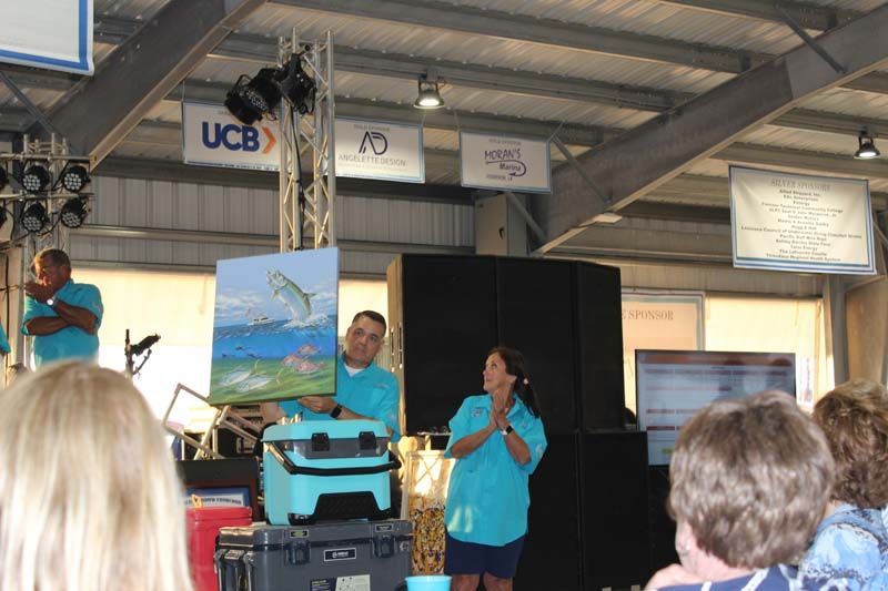 A group of people standing in front of a sign that says ucb