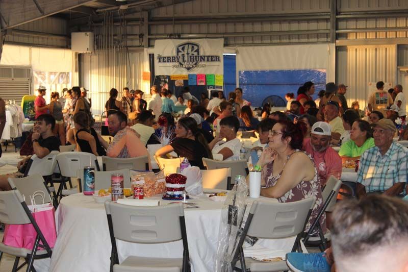 A large group of people are sitting at tables in a large room