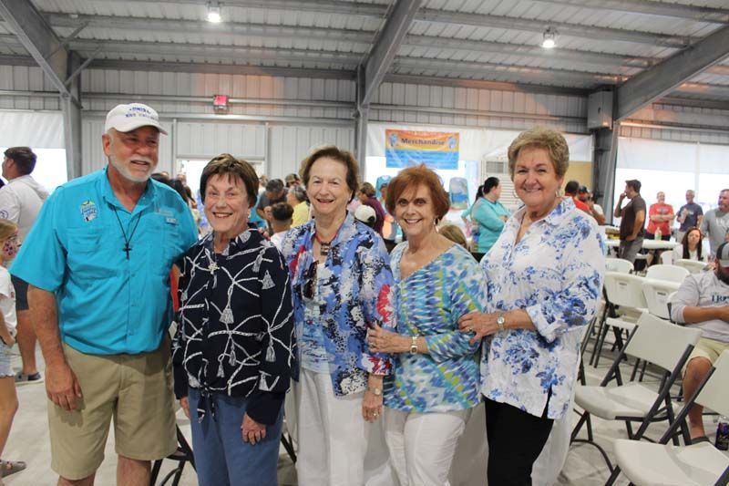A group of people are posing for a picture in a room.
