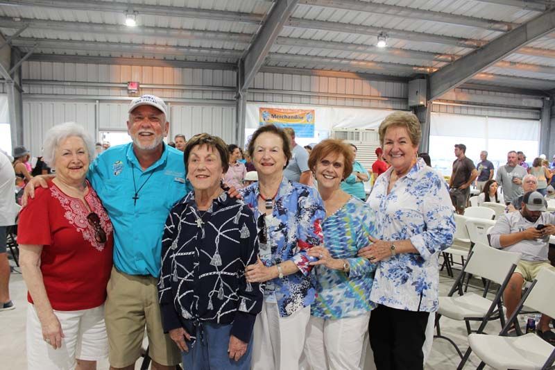A group of people are posing for a picture in a room.