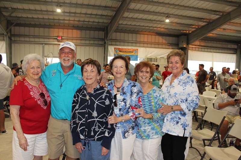 A group of people are posing for a picture in a room.