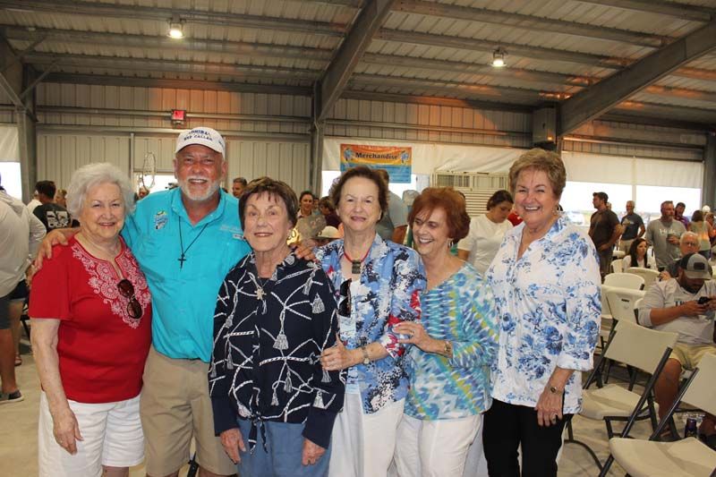A group of people are posing for a picture in a room.