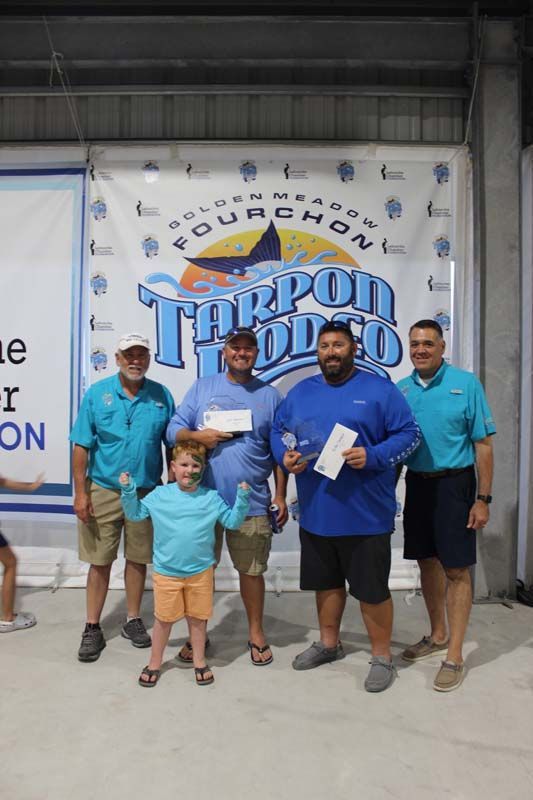 A group of men are standing next to each other in front of a banner.