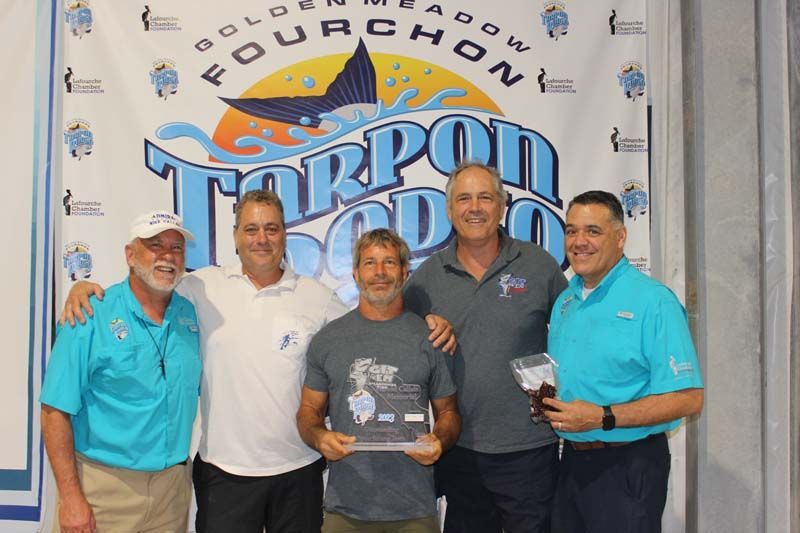 A group of men standing in front of a banner that says four chow