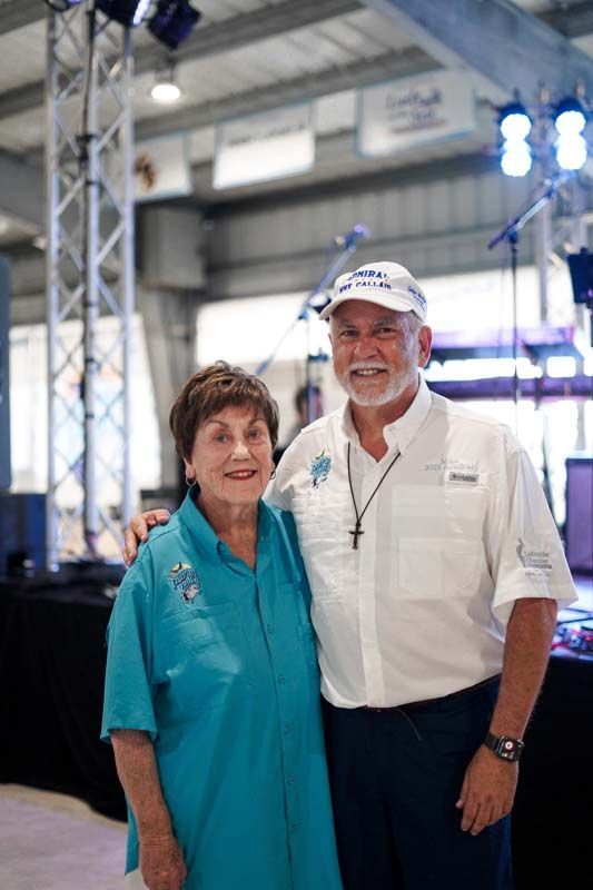 A man and a woman are posing for a picture in a room.