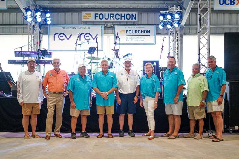 A group of people are standing in front of a stage.