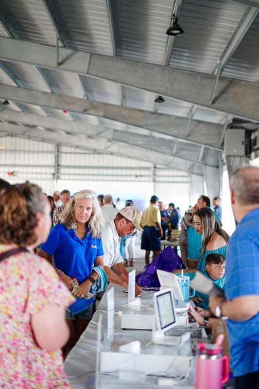 A group of people are standing around a table in a building.