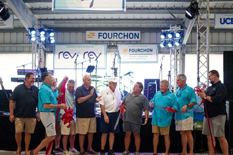 A group of men are standing in front of a stage.