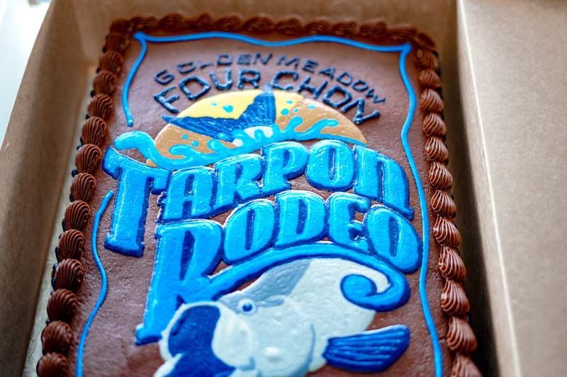 A chocolate cake with the words tarpon rodeo on it