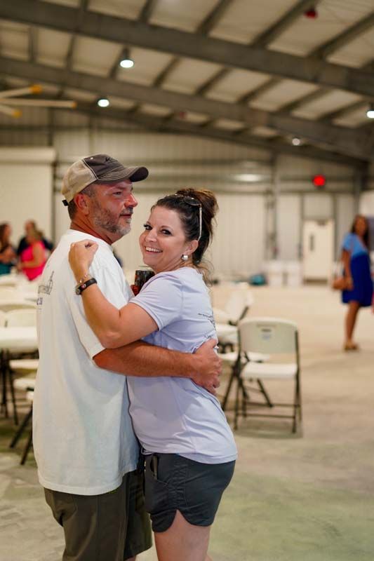 A man and a woman are dancing together in a room.