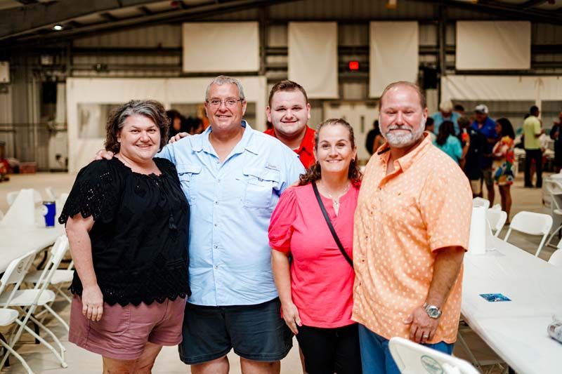 A group of people are posing for a picture in a room.