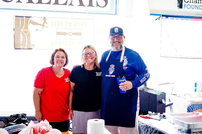 A group of people are standing next to each other in a room.