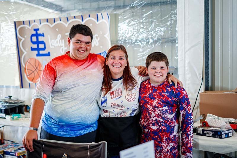 A group of young people are posing for a picture together.