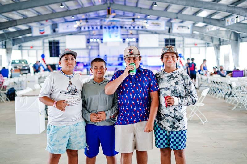 A group of young men are posing for a picture in a large room.