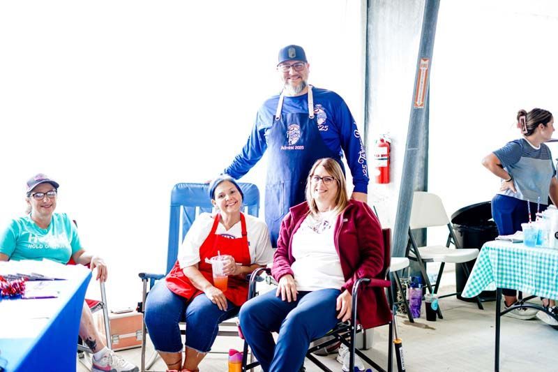 A group of people are sitting in chairs and posing for a picture.