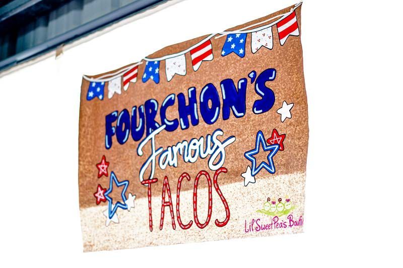 A sign that says fourchon 's famous tacos on it