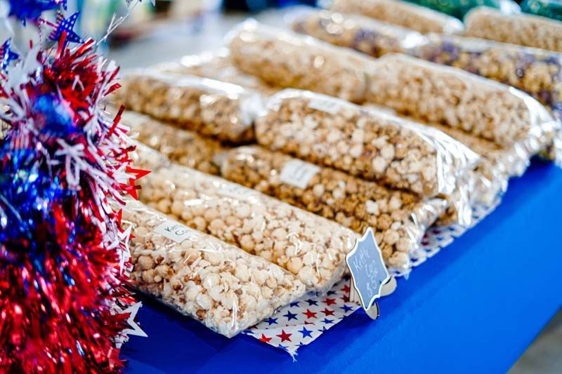 There are many bags of popcorn on the table.