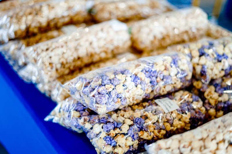A bunch of bags of popcorn are sitting on a table.