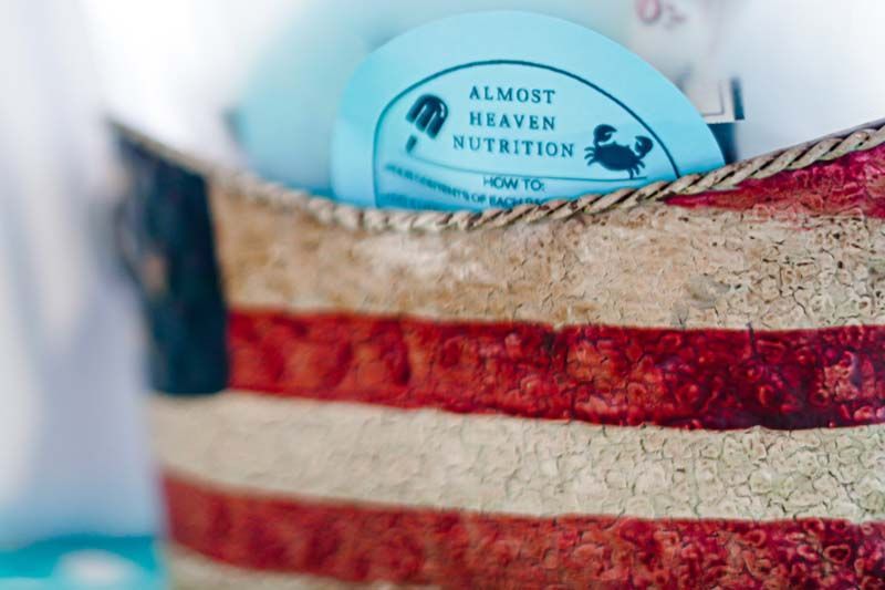 A close up of an american flag purse with a sticker on it that says almost heaven nutrition.
