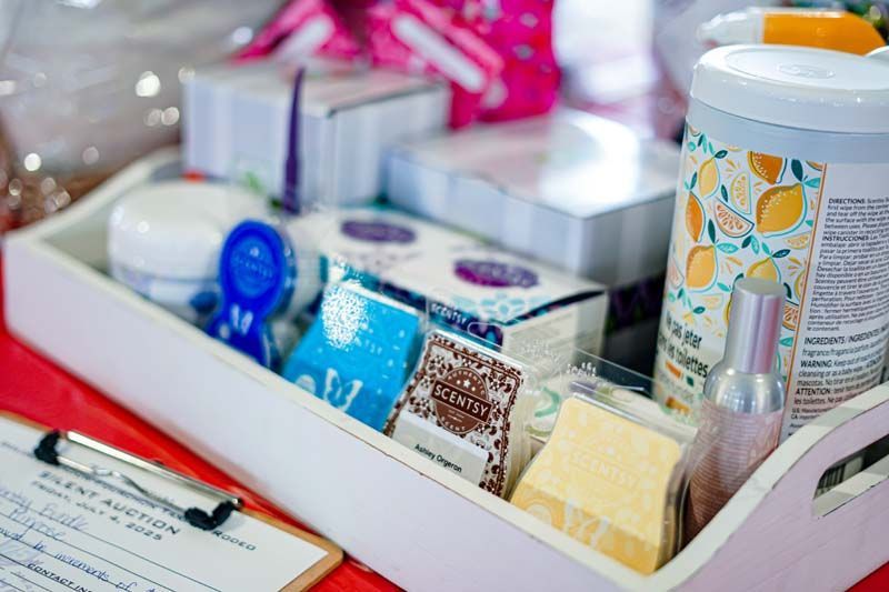 A white tray filled with various cosmetics and a clipboard on a table.